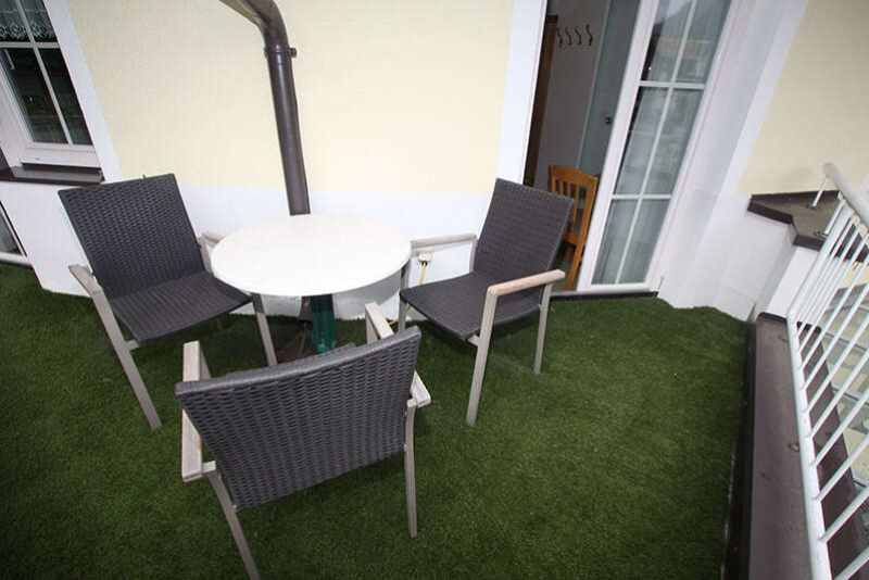 Balcony with seating area from apartment 3 in Apart Gruber