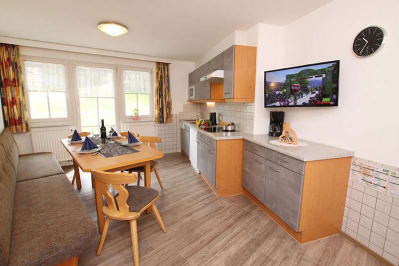 Kitchen with dining area in apartment 3 at Apart Gruber in Ischgl